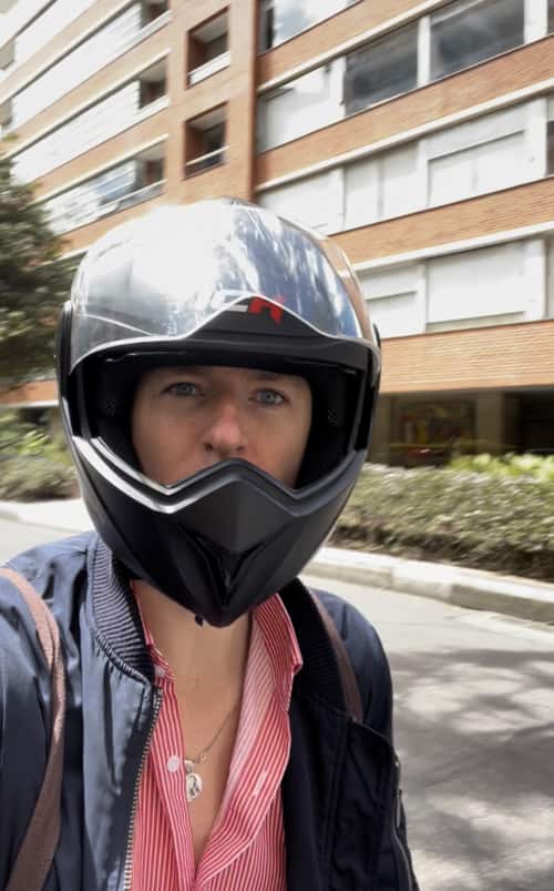 Ladislas Maurice wearing a scooter helmet investigating real estate investment in Bogota