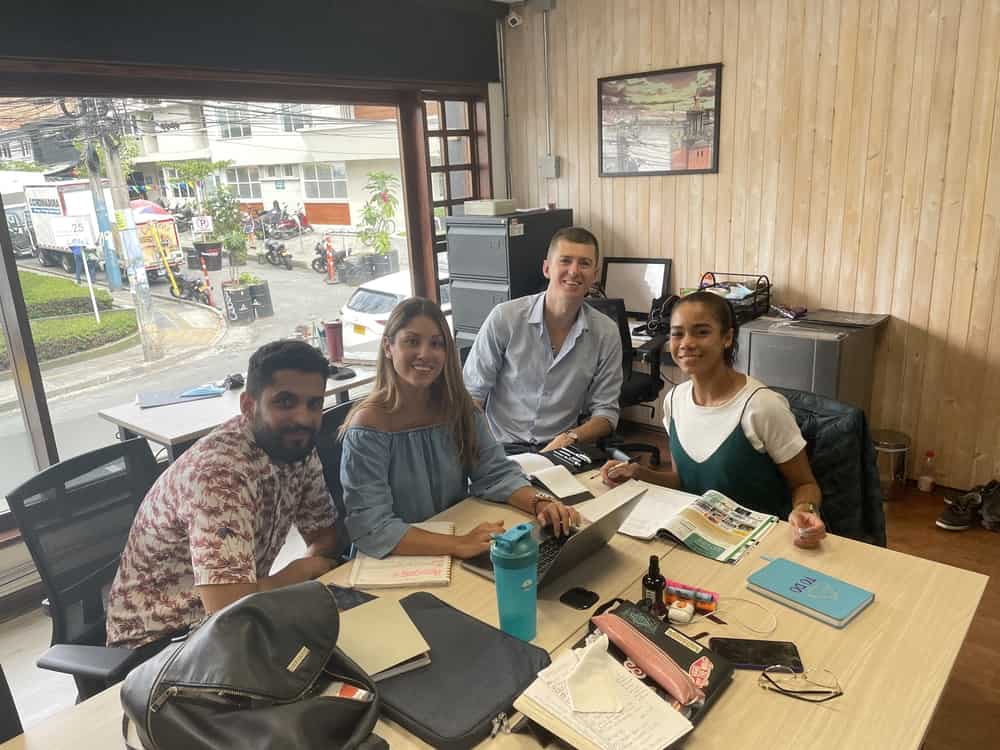 Four people sitting in Medellin real estate office